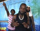Mavado (C), Jamaican dancehall star, joined in the street festivities in Roseau, October 26., 2018 in Roseau, Dominica. - Amid the kaleidoscope of colors of Dominica's capital Roseau, the streets pulsated with the sounds of African drums and steelpans, bamboo "boom pipes" and accordions. Impromptu parties sprung up on roadsides and beaches for the weekend of revelry that is the World Creole Music Festival, a chance to showcase the origins of the now global but intrinsically Caribbean sound. The 20th edition of the festival brought thousands from across the Caribbean to the tiny island nation and sent a message that Dominica has moved on from Hurricane Maria, which last year claimed dozens of lives here as it obliterated homes and livelihoods. (Photo by Gemma HANDY / AFP) (Photo credit should read GEMMA HANDY/AFP/Getty Images)